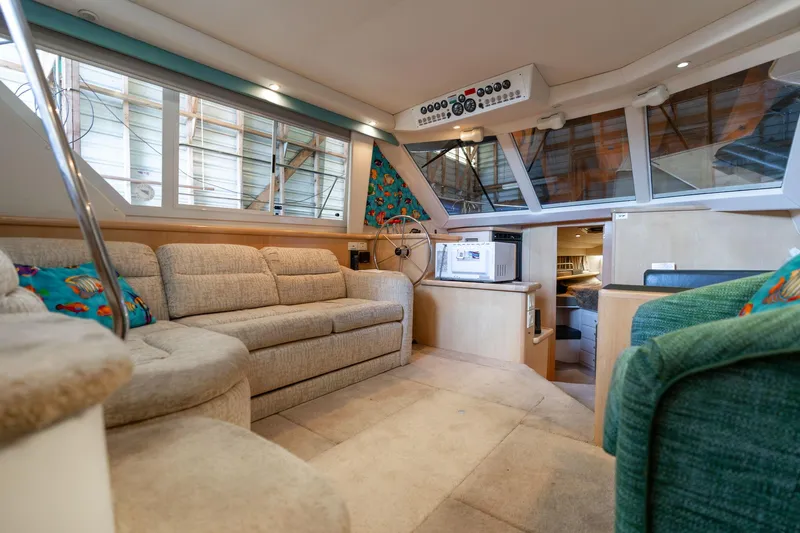 Shore Leave Yacht Photos Pics 1998 Carver 355 Aft Cabin interior with beige seating and nautical decor.