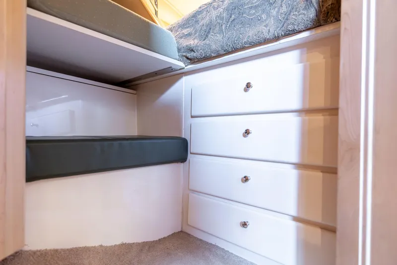 Shore Leave Yacht Photos Pics 1998 Carver 355 Aft Cabin interior with white drawers and cushioned seating.