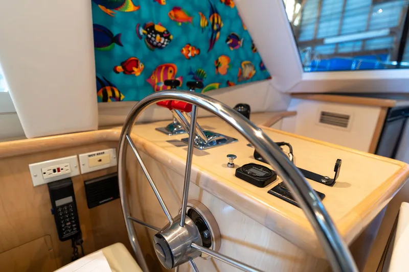 Shore Leave Yacht Photos Pics Interior helm of 1998 Carver 355 Aft Cabin with colorful fish-themed curtain.