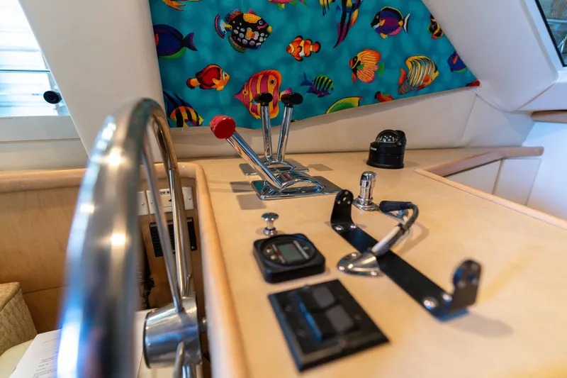 Shore Leave Yacht Photos Pics 1998 Carver 355 Aft Cabin helm with colorful fish curtain and navigation controls.