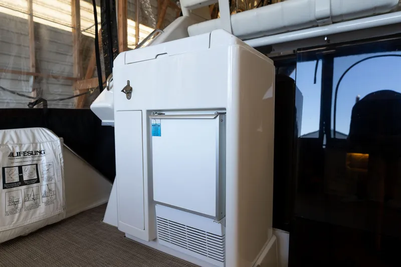 Shore Leave Yacht Photos Pics 1998 Carver 355 Aft Cabin interior with compact refrigerator and lifesaving equipment.