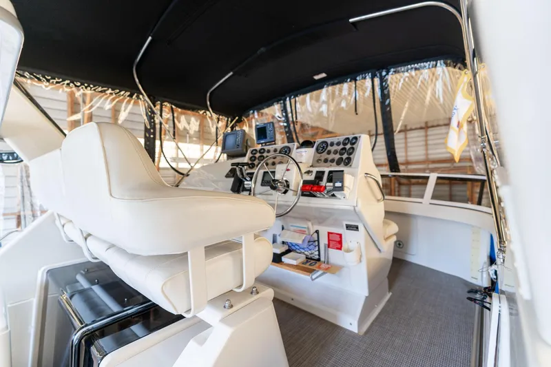 Shore Leave Yacht Photos Pics 1998 Carver 355 Aft Cabin helm with white seating and navigation instruments.