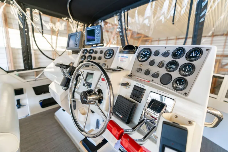 Shore Leave Yacht Photos Pics Control panel of a 1998 Carver 355 Aft Cabin boat with gauges and navigation equipment.