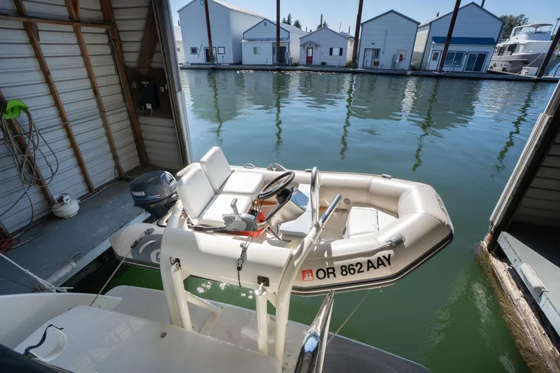Shore Leave Yacht Photos Pics Inflatable boat docked near Carver 355 Aft Cabin, 1998, in a marina setting.