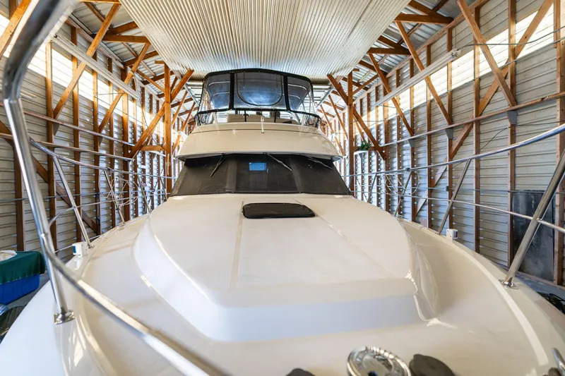 Shore Leave Yacht Photos Pics 1998 Carver 355 Aft Cabin yacht in a wooden boathouse.