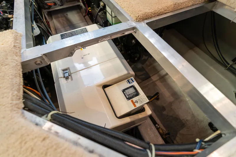 Shore Leave Yacht Photos Pics Engine compartment of a 1998 Carver 355 Aft Cabin boat, showing mechanical components.