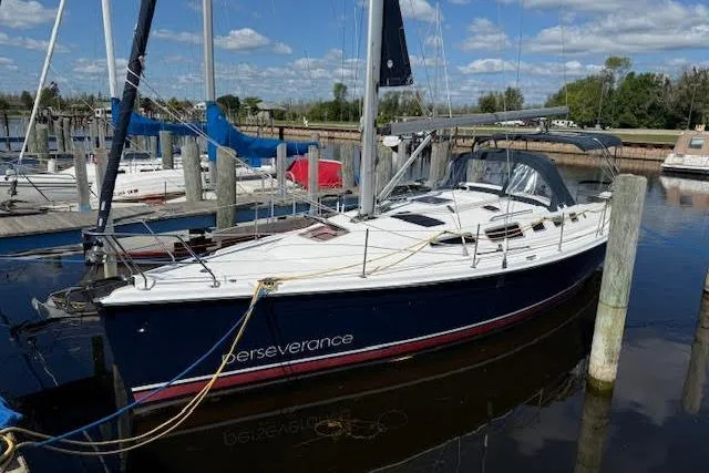 Yacht Photos Pics 2005 Hunter 38 sailboat named "Perseverance" docked at a marina under a blue sky.