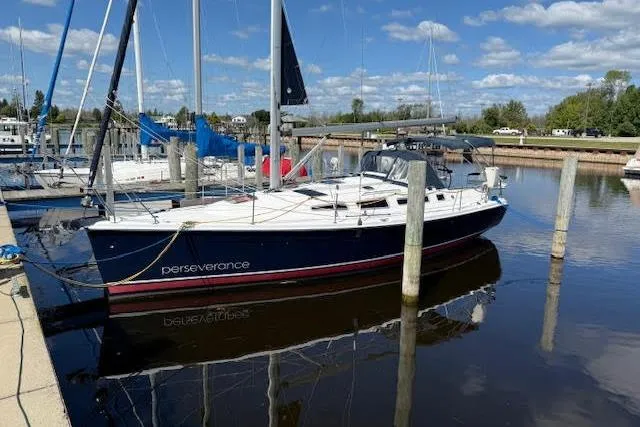  Yacht Photos Pics Hunter 38 sailboat, 2005 model, docked in a marina under a clear blue sky.