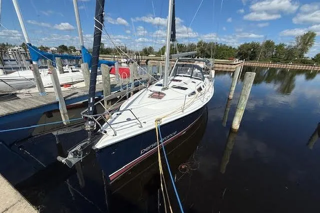  Yacht Photos Pics Hunter 38 sailboat from 2005 docked at a marina under a clear blue sky.
