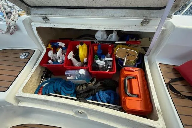  Yacht Photos Pics Storage compartment on a 2005 Hunter 38 sailboat with cleaning supplies and ropes.