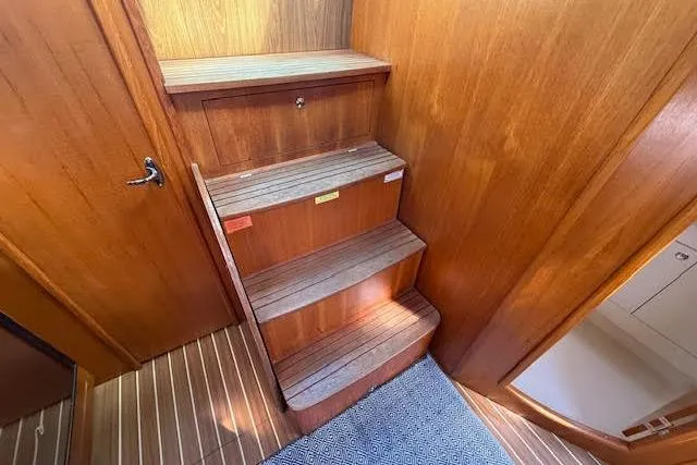  Yacht Photos Pics Wooden interior stairs on a 2005 Hunter 38 yacht, featuring a sleek design.