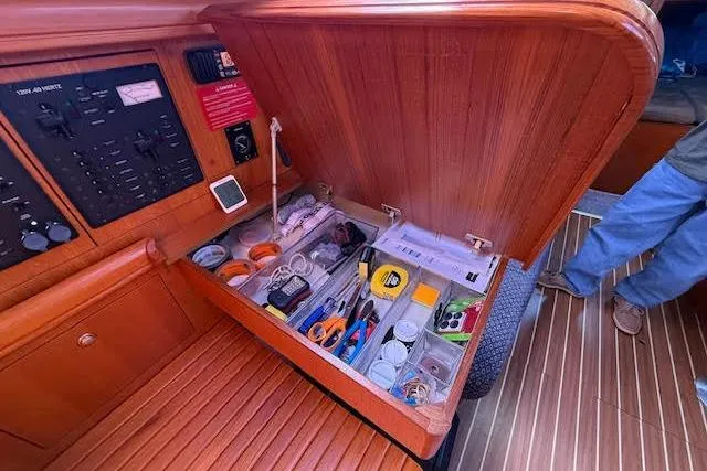  Yacht Photos Pics Interior of 2005 Hunter 38 sailboat with open storage compartment and navigation panel.