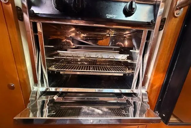  Yacht Photos Pics 2005 Hunter 38 oven interior with metal racks and trays, showcasing stainless steel design.