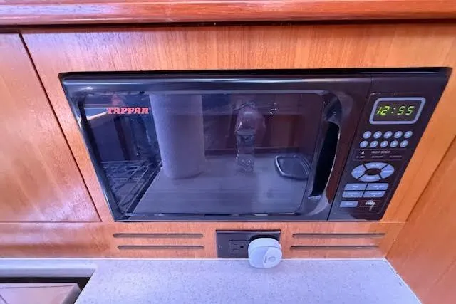  Yacht Photos Pics Built-in Tappan microwave in 2005 Hunter 38 yacht kitchen, featuring digital controls.