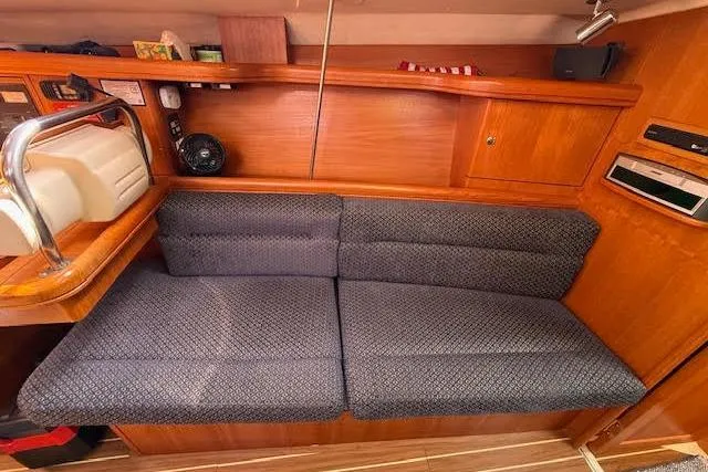  Yacht Photos Pics Interior of 2005 Hunter 38 sailboat with cushioned seating and wooden cabinetry.