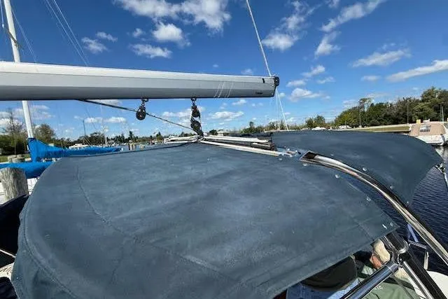  Yacht Photos Pics 2005 Hunter 38 sailboat with blue canvas cover and clear sky background.