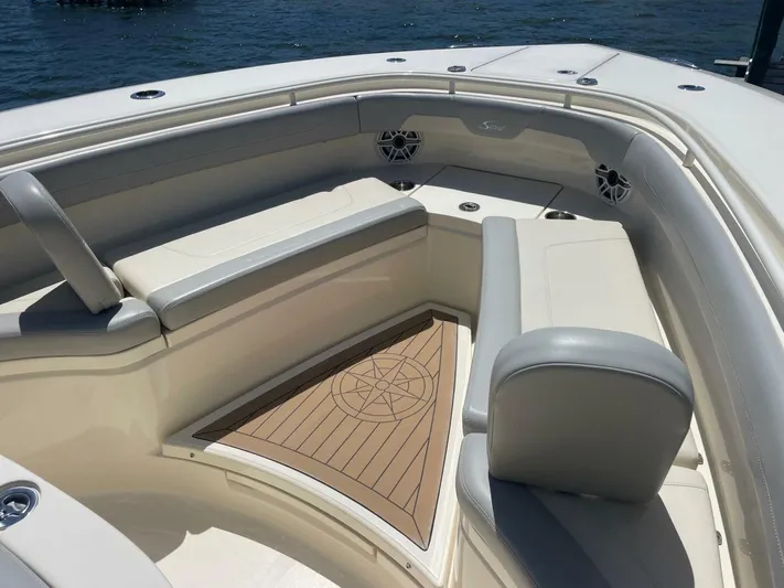 Exit Strategy Yacht Photos Pics 2020 Scout 355 LXF Center Console boat with cushioned seating and teak flooring.