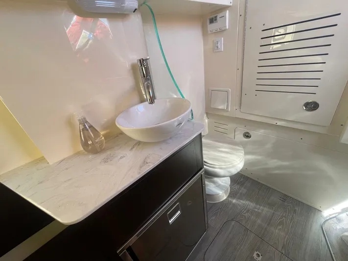 Exit Strategy Yacht Photos Pics 2020 Scout 355 LXF Center Console boat bathroom with modern sink and toilet.