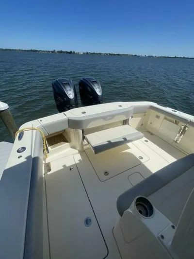 Exit Strategy Yacht Photos Pics 2020 Scout 355 LXF Center Console boat with twin outboard motors on a calm lake.