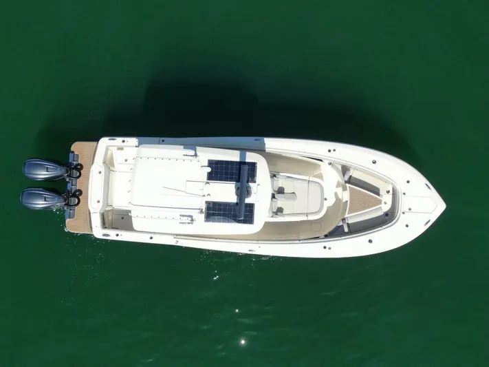 Exit Strategy Yacht Photos Pics 2020 Scout 355 LXF Center Console boat on water, aerial view.