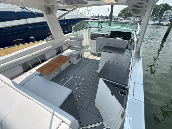 Head Honcho Yacht Photos Pics 2021 Aviara AV36 I/O boat interior with seating, table, and helm, docked at marina.