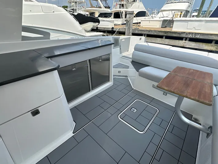 Head Honcho Yacht Photos Pics 2021 Aviara AV36 I/O boat interior with seating, table, and storage.