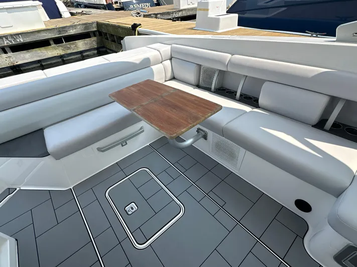 Head Honcho Yacht Photos Pics 2021 Aviara AV36 I/O boat interior with gray seating and wooden table.
