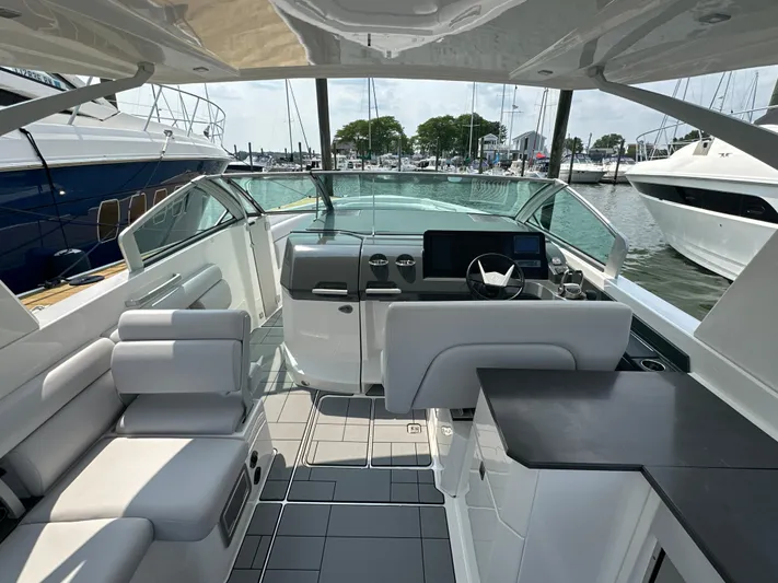 Head Honcho Yacht Photos Pics 2021 Aviara AV36 I/O boat interior with modern seating and helm, docked at marina.