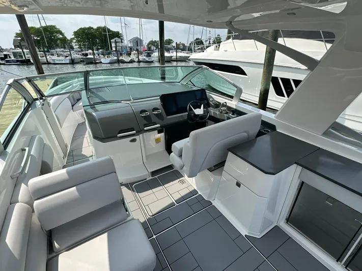 Head Honcho Yacht Photos Pics 2021 Aviara AV36 I/O boat interior with modern seating and helm, docked at marina.