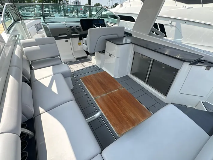 Head Honcho Yacht Photos Pics 2021 Aviara AV36 I/O boat interior with seating, table, and helm.