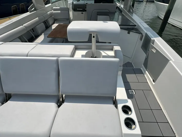 Head Honcho Yacht Photos Pics 2021 Aviara AV36 I/O boat interior with white seating and wooden table.