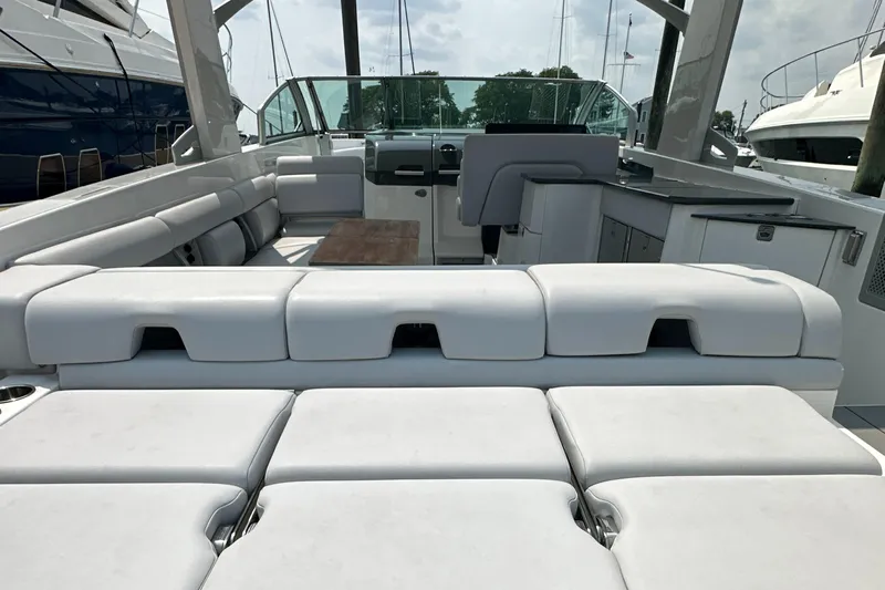 Head Honcho Yacht Photos Pics 2021 Aviara AV36 I/O boat interior with white seating and wooden table.