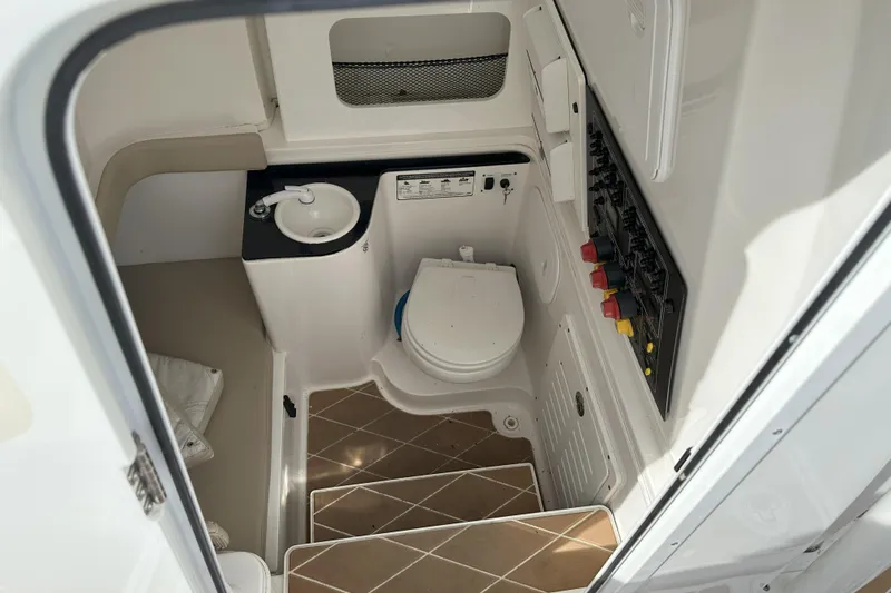  Yacht Photos Pics 2018 Sea Fox 328 Commander boat bathroom with toilet, sink, and control panel.