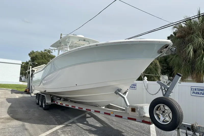  Yacht Photos Pics 2018 Sea Fox 328 Commander boat on trailer in parking lot, side view.
