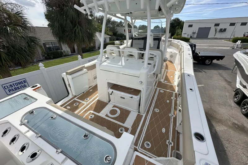  Yacht Photos Pics 2018 Sea Fox 328 Commander boat interior with seating and storage, docked in a parking area.