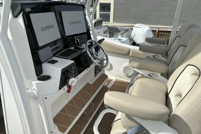  Yacht Photos Pics 2018 Sea Fox 328 Commander boat cockpit with Garmin displays and beige seating.