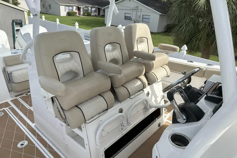  Yacht Photos Pics 2018 Sea Fox 328 Commander boat interior with beige captain chairs and steering console.