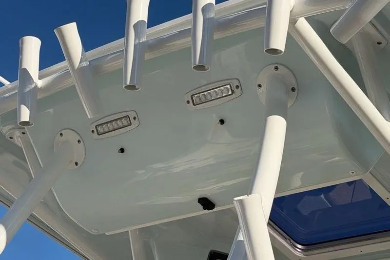  Yacht Photos Pics 2018 Sea Fox 328 Commander boat with rod holders and LED lights against blue sky.