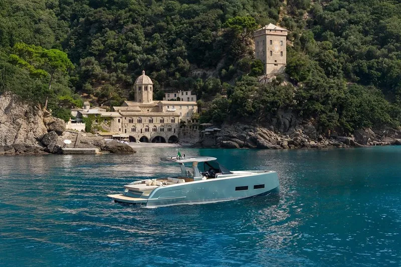 Nouveau Pardo 43 2026 Yacht Photos Pics 2026 Pardo Yachts P43 cruising near historic coastal architecture and lush greenery.