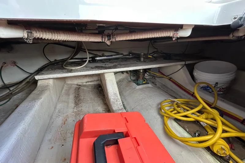 Solitude Yacht Photos Pics 2008 Back Cove 33 boat interior with red toolbox, yellow cables, and white bucket.