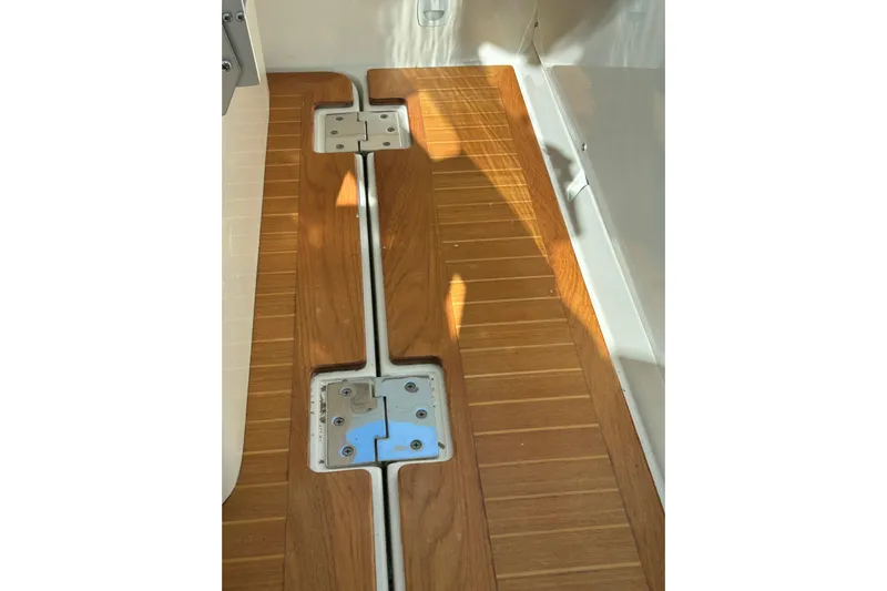 Solitude Yacht Photos Pics Teak deck flooring on a 2008 Back Cove 33 boat, featuring metal hatch fittings.
