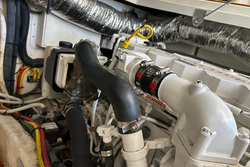 Solitude Yacht Photos Pics Engine compartment of a 2008 Back Cove 33 boat, showing hoses and components.