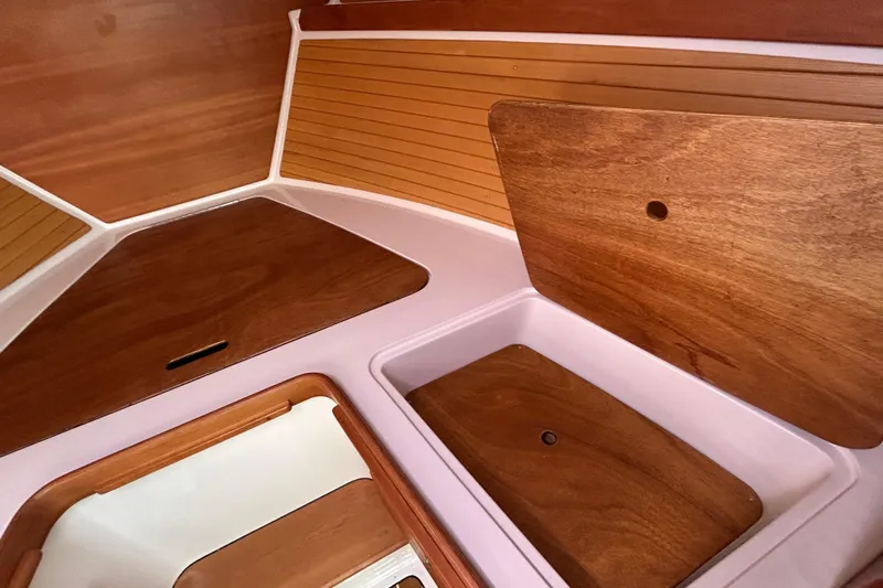 Solitude Yacht Photos Pics Interior of 2008 Back Cove 33 boat with wooden paneling and storage compartments.