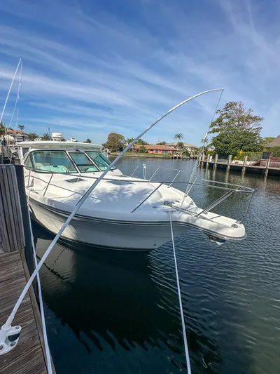  Yacht Photos Pics 2006 Tiara Yachts 3200 Open docked in a serene marina setting.