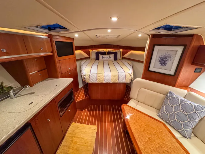  Yacht Photos Pics Luxurious 2006 Tiara Yachts 3200 Open cabin with cozy bed and elegant wood finishes.