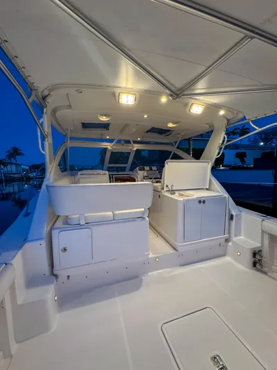  Yacht Photos Pics 2006 Tiara Yachts 3200 Open, illuminated deck at dusk, showcasing sleek design and spacious layout.