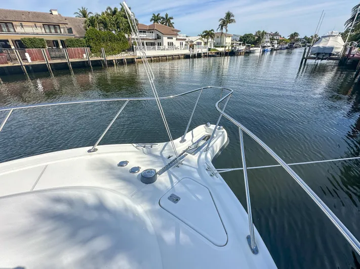  Yacht Photos Pics 2006 Tiara Yachts 3200 Open on a serene canal with waterfront homes.