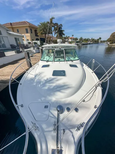  Yacht Photos Pics 2006 Tiara Yachts 3200 Open docked by waterfront homes under a clear sky.