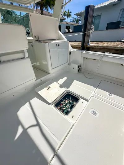  Yacht Photos Pics 2006 Tiara Yachts 3200 Open interior with storage compartment, docked under sunny skies.