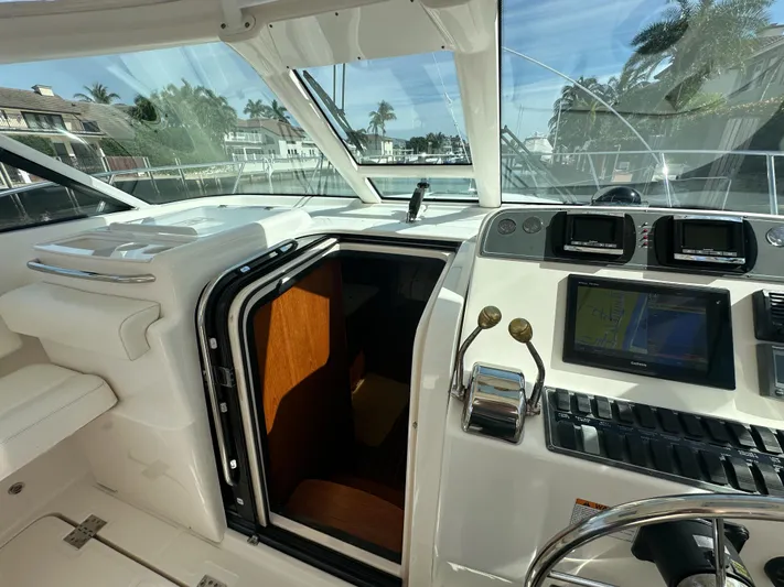  Yacht Photos Pics 2006 Tiara Yachts 3200 Open helm with navigation equipment and cabin entrance.